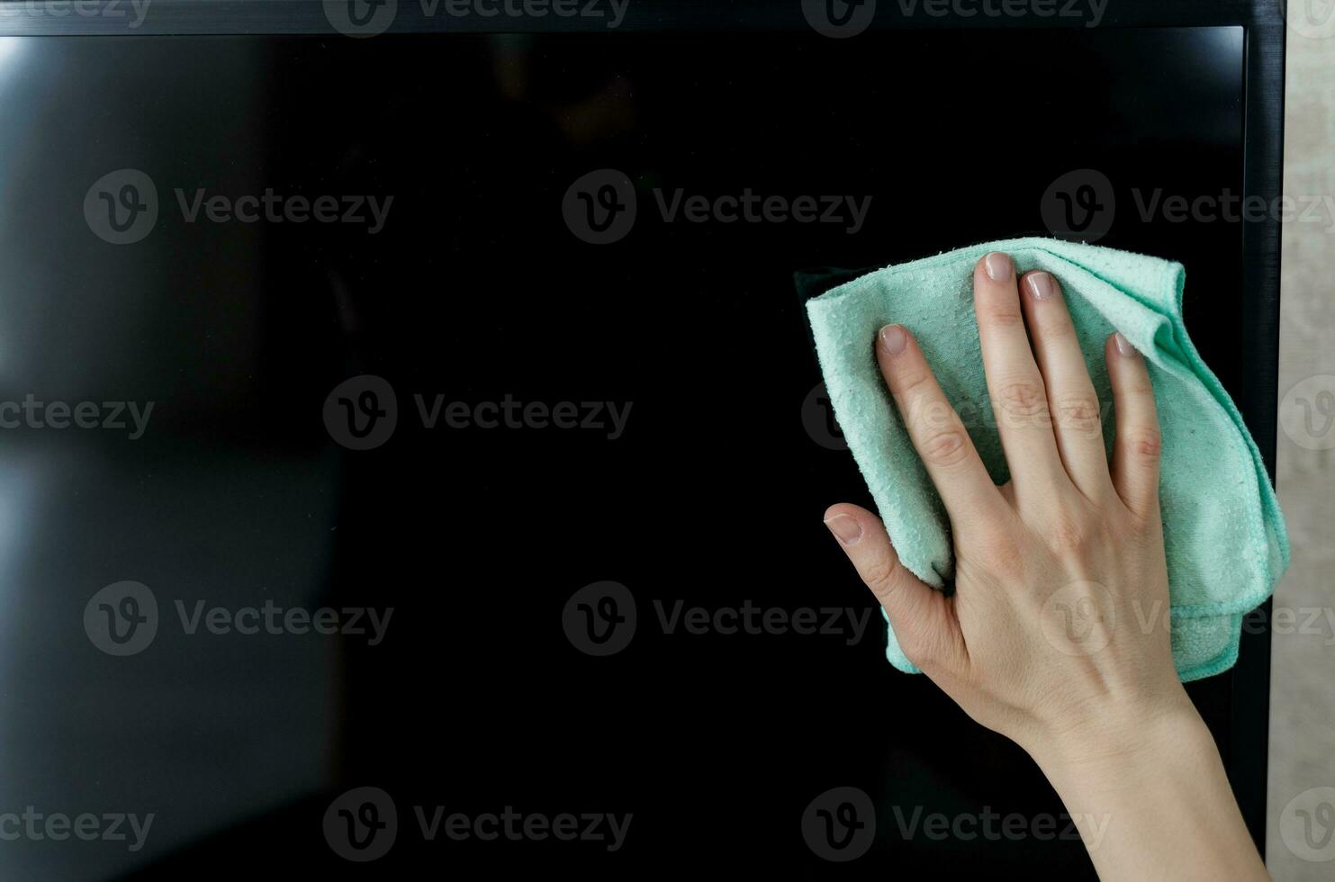 Hand Cleaning Television With Cloth photo