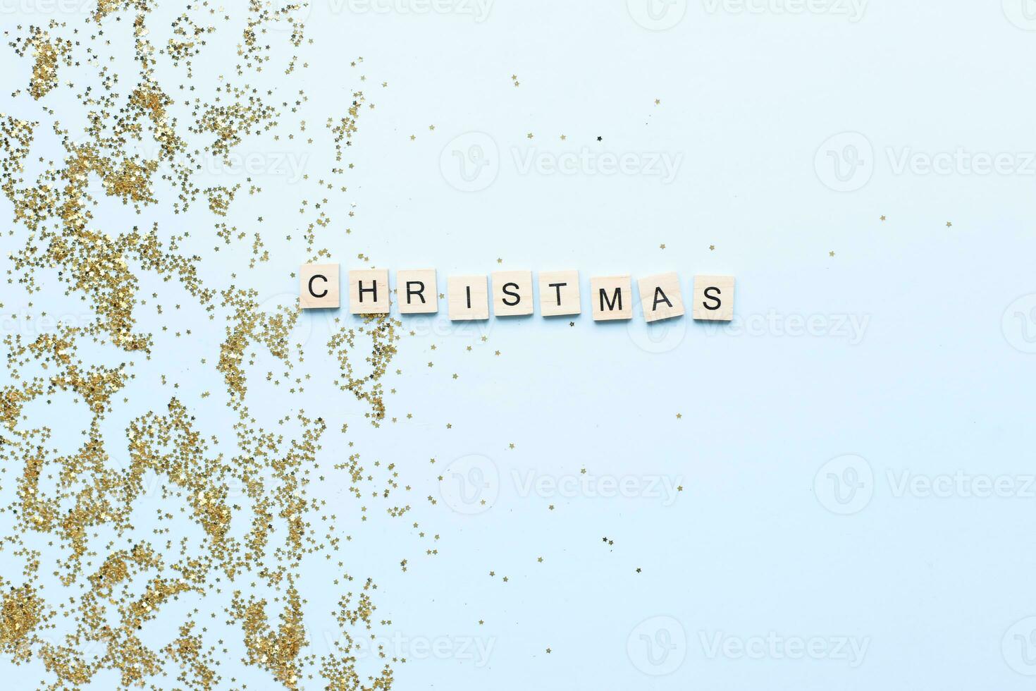 Flat lay Word christmas from wooden letters on glitters. Shine. Star sequins photo