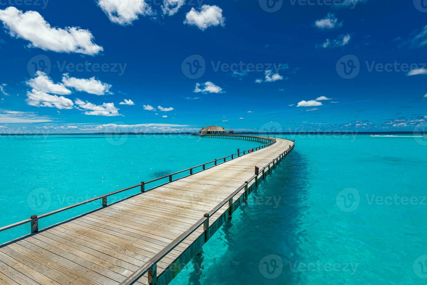 Amazing sunny panorama at Maldives. Luxury resort villas seascape with boost up colors, blue sea sky, fantastic jetty. Perfect summer vacation holiday background. Tranquil tropical beach landscape photo