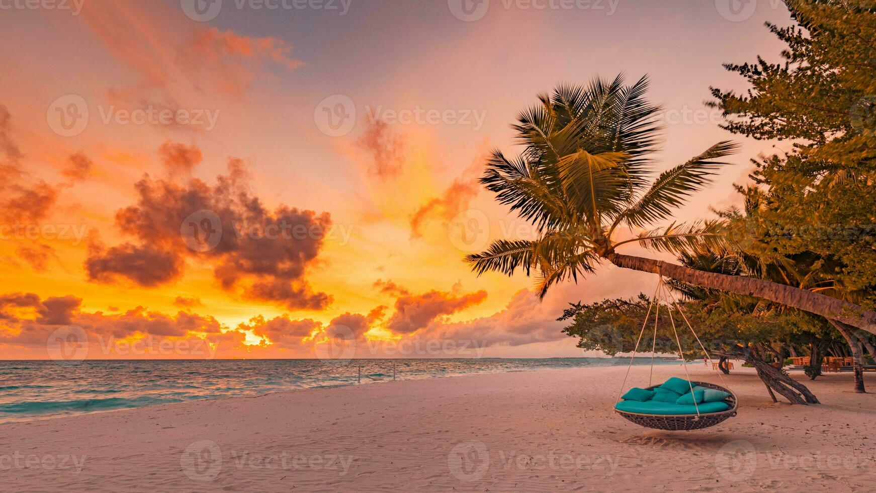 Sea sand sky concept, sunset colors clouds, horizon. Inspirational nature landscape, beautiful colors, wonderful scenery of tropical beach. Beach swing or hammock for luxury summer vacation holiday photo