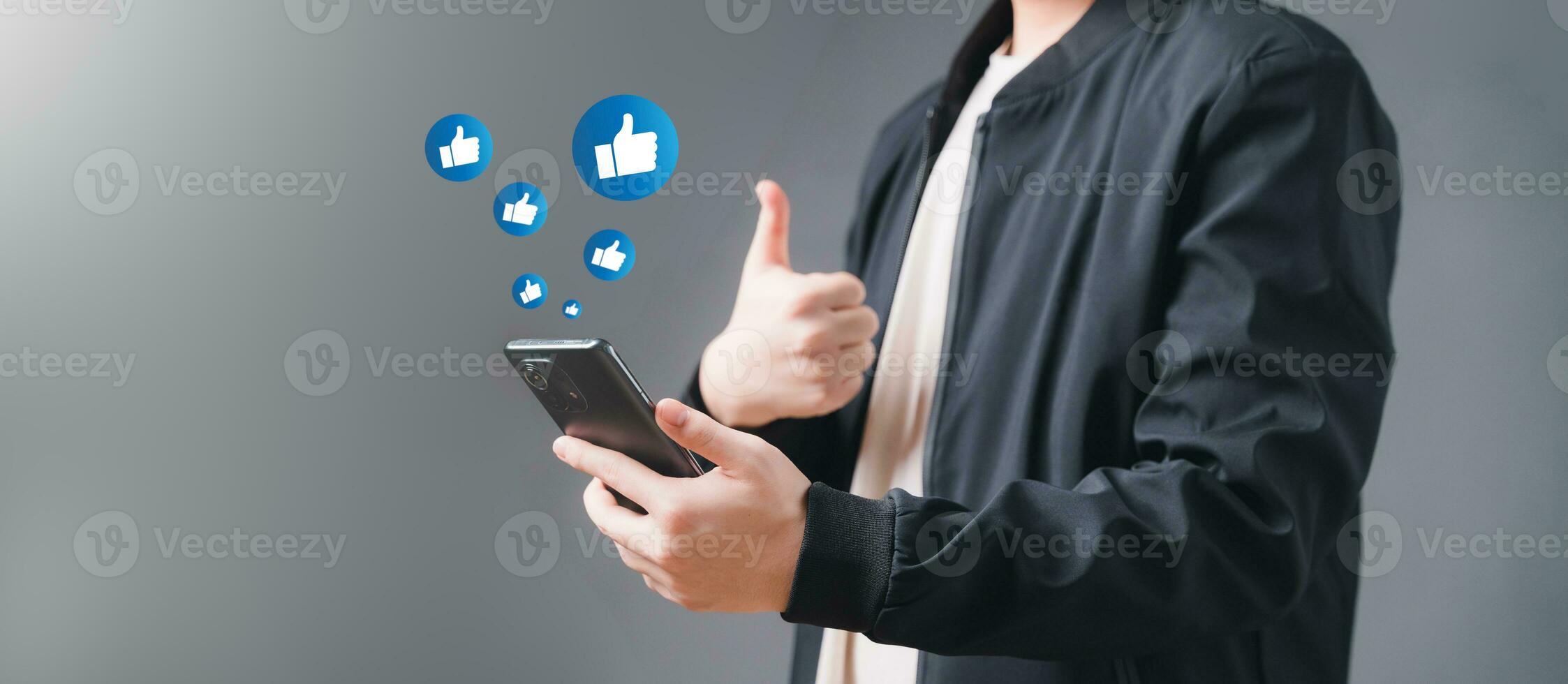 Young man Like and using smart phone with Social media. The concept of Social media and digital online. Watch Live streaming and Like message, likes, emoji feedback. photo