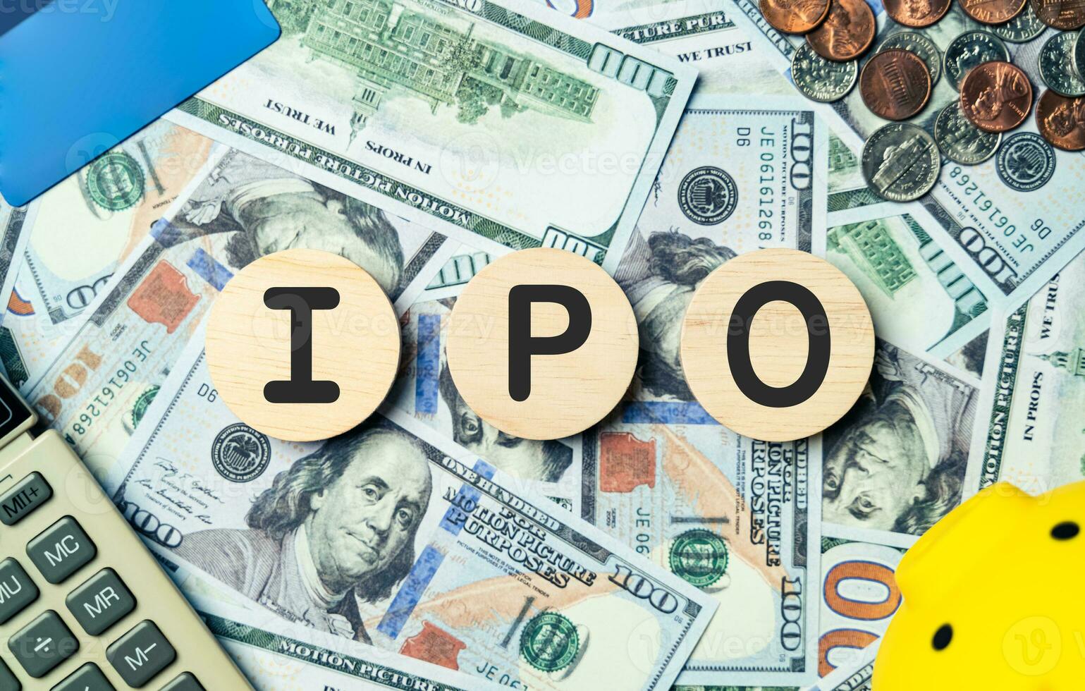 IPO text in wooden circle on Banknotes background, credit card ...