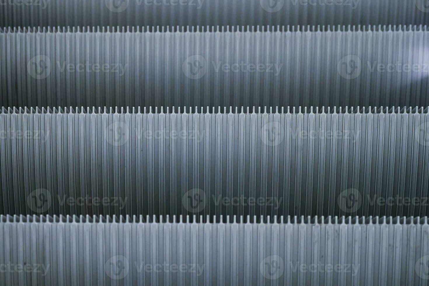 Abstract Shiny Gray pattern of metal escalator foot step texture background photo