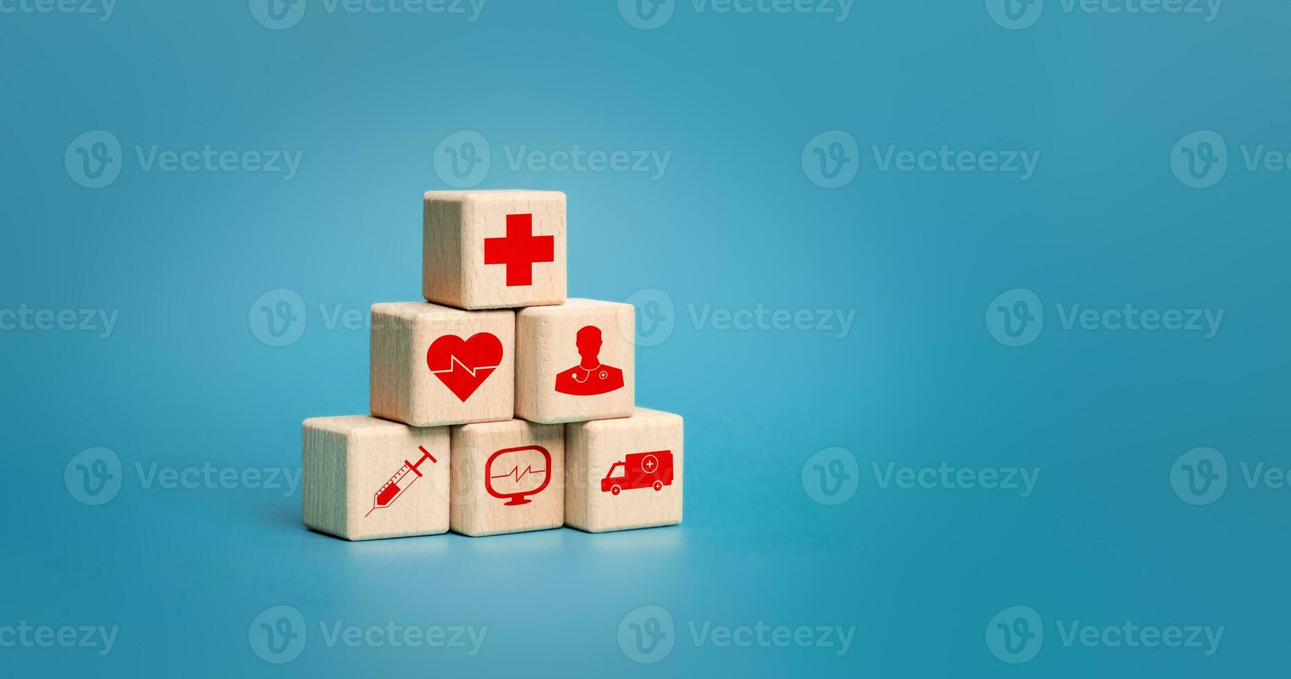 Healthcare. Stacking Pyramid of health and medical icon on wooden cubes with copy space on blue background for health insurance, wellness, wellbeing concept. vaccination, medical technology. photo