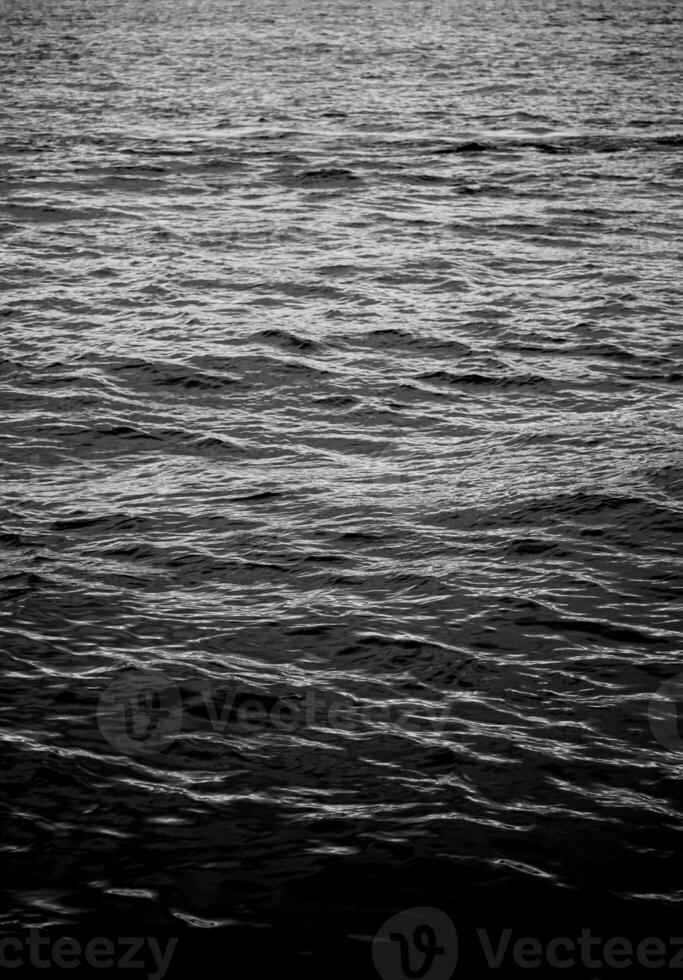 Reflect ripple water texture background. High resolution wallpaper of dark water. Abstract surface sea water in black and white photography. photo