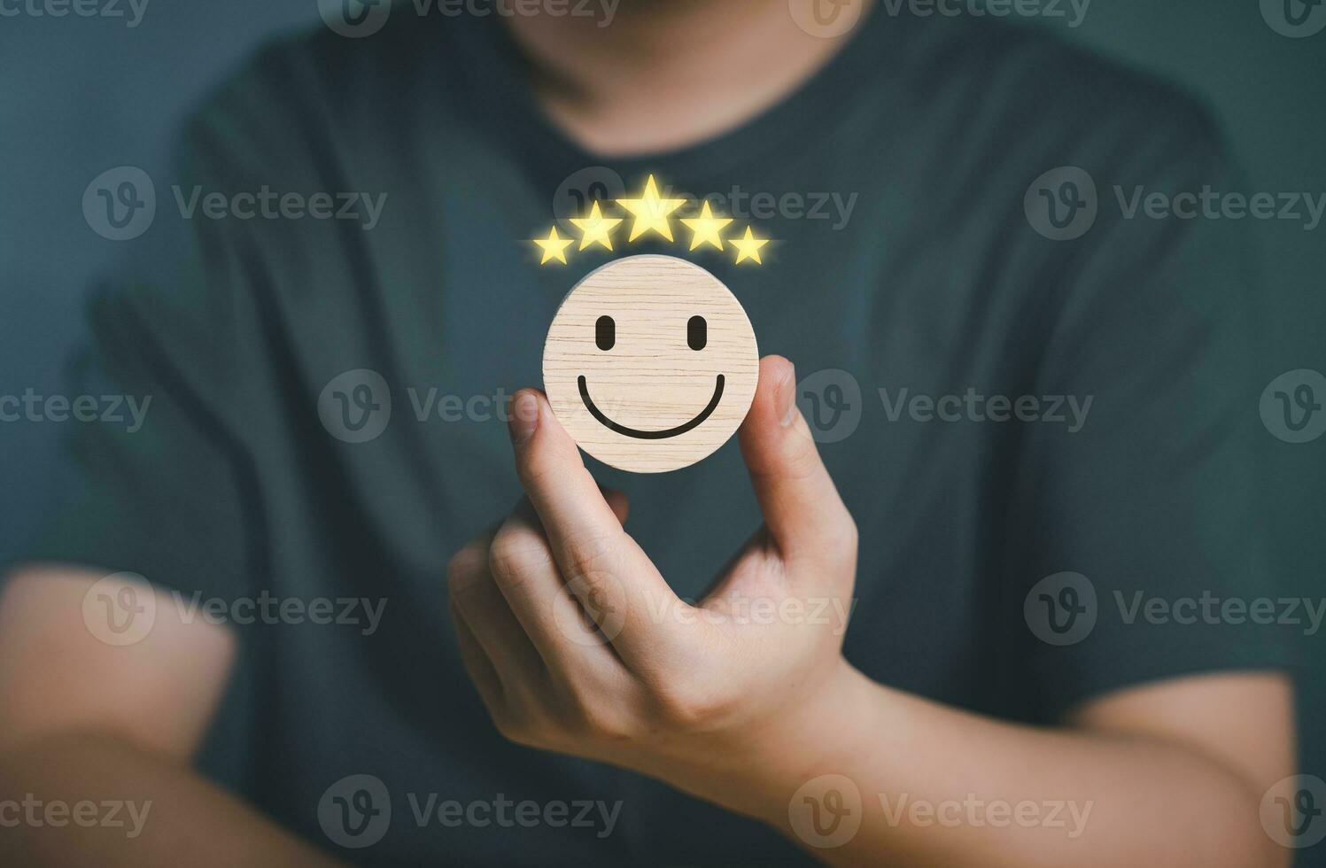 Hand of customer picking happy face rate service or products. Wooden circle for positive mindset selection, online business and marketing customer satisfaction review, evaluation and feedback concept. photo