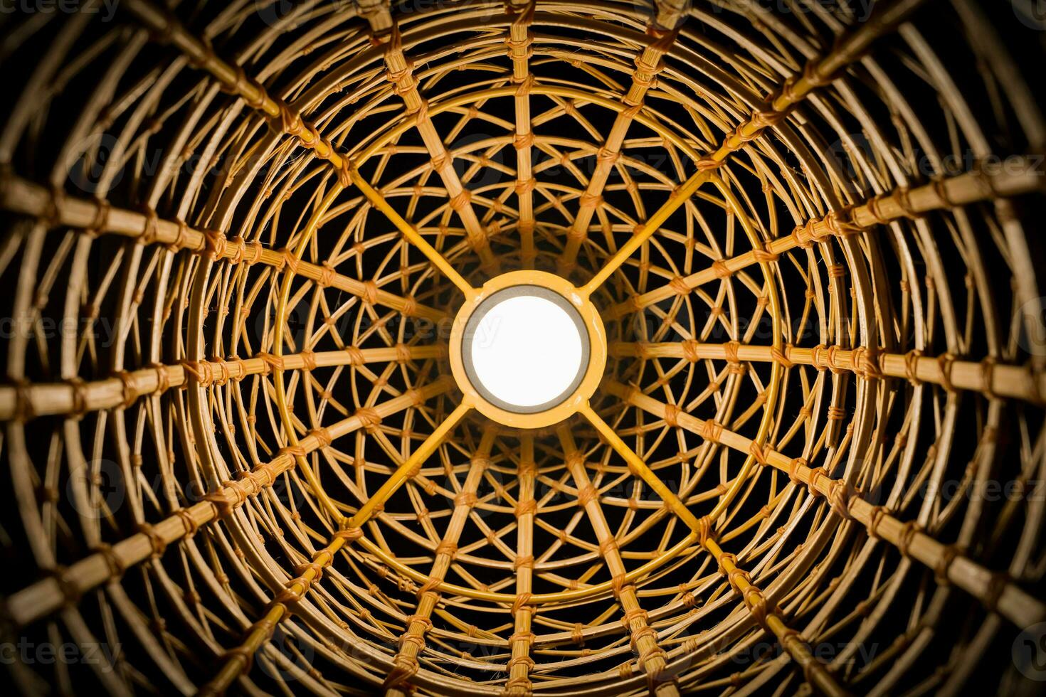 Perspective Photography of wicker texture with a handmade traditional light bulb, abstract background. The ancient classic pattern of bamboo Thai wickerwork. photo