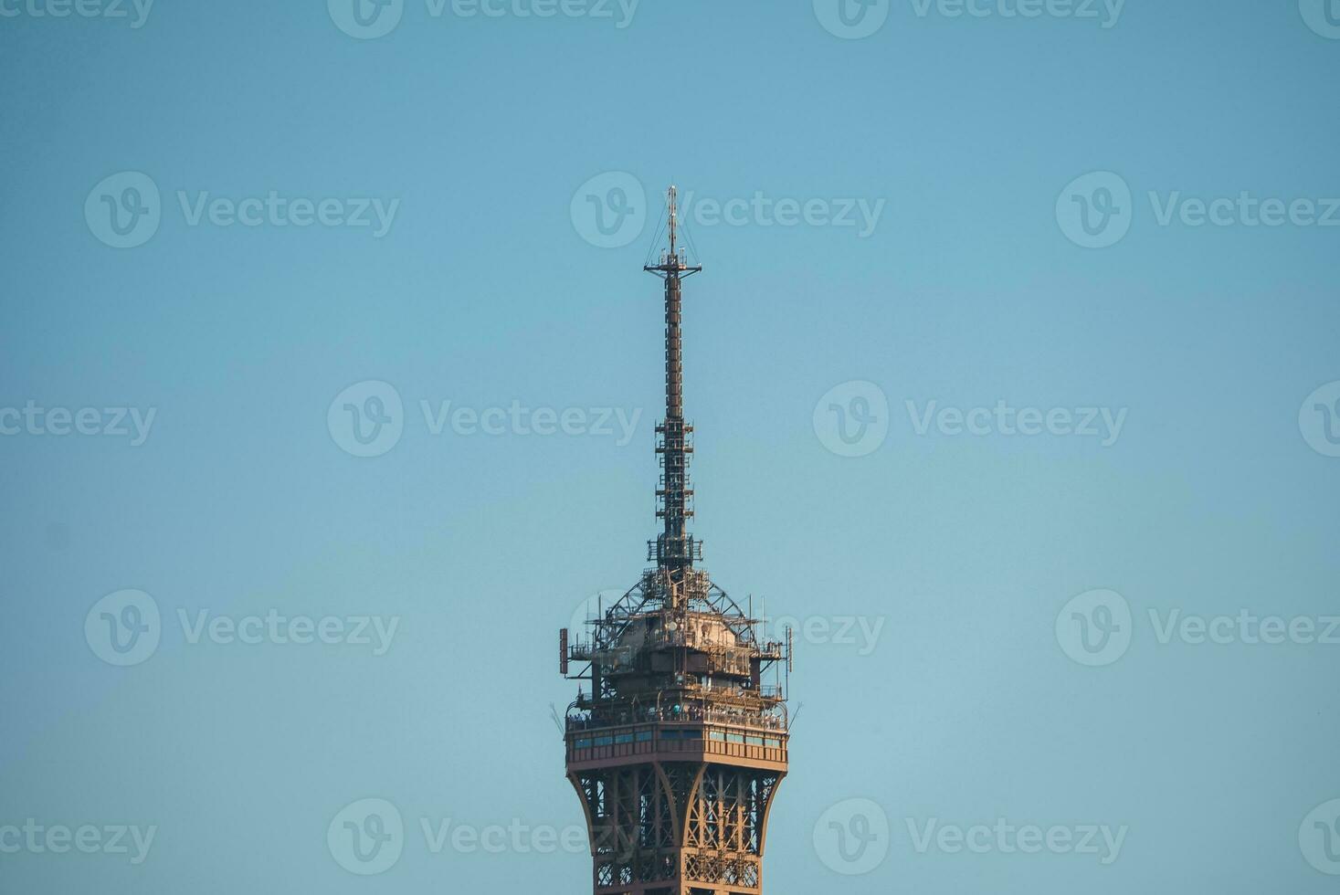 Eiffel Tower Top Close-Up Against Blue Sky photo