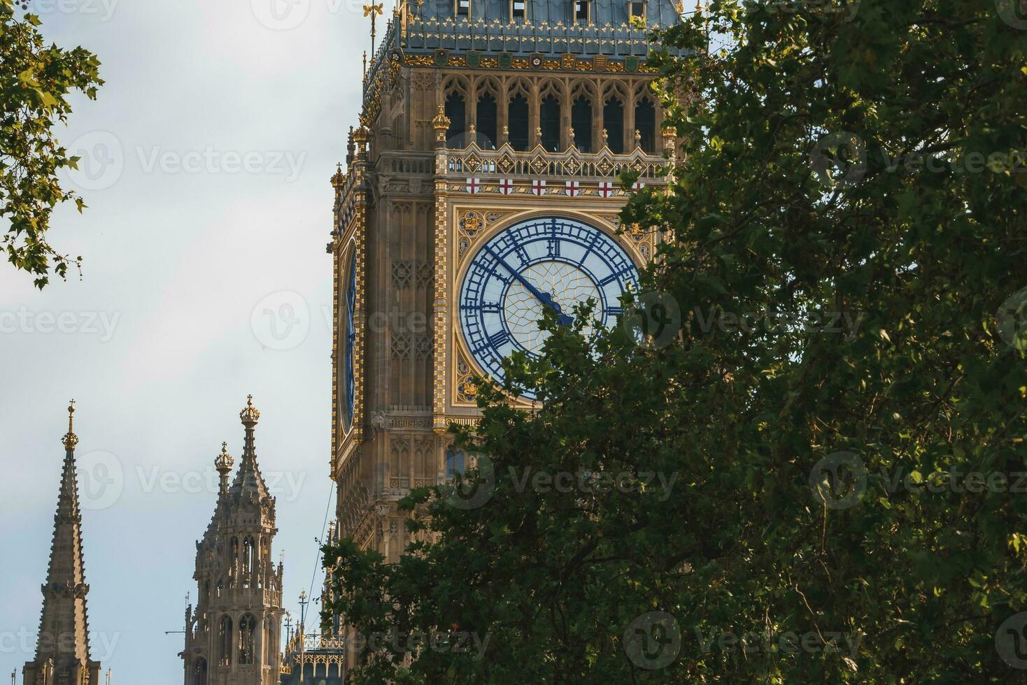 Big Ben clocktower and Westminster palace with cloudy sky in background photo