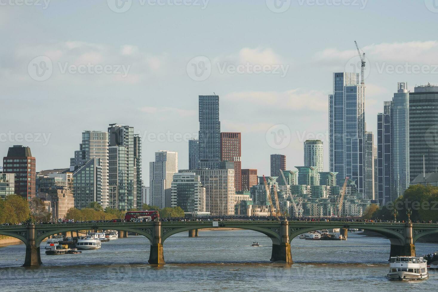 View of Westminster bridge over Thames river with cityscape in background photo