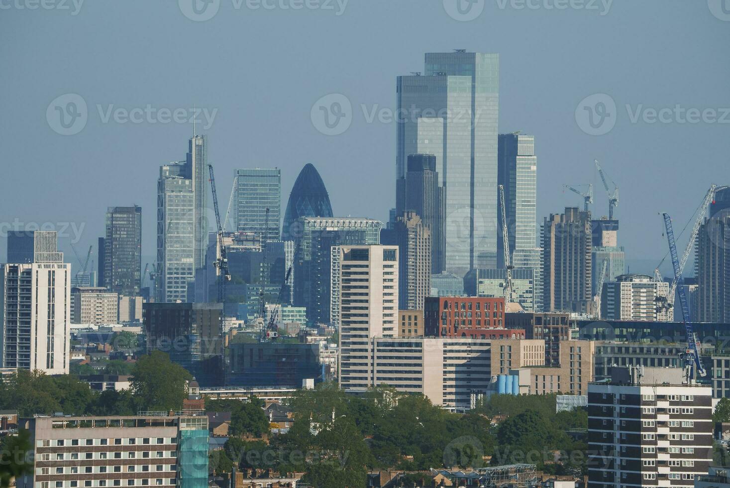 View of crowded cityscape with blue sky in background at London photo