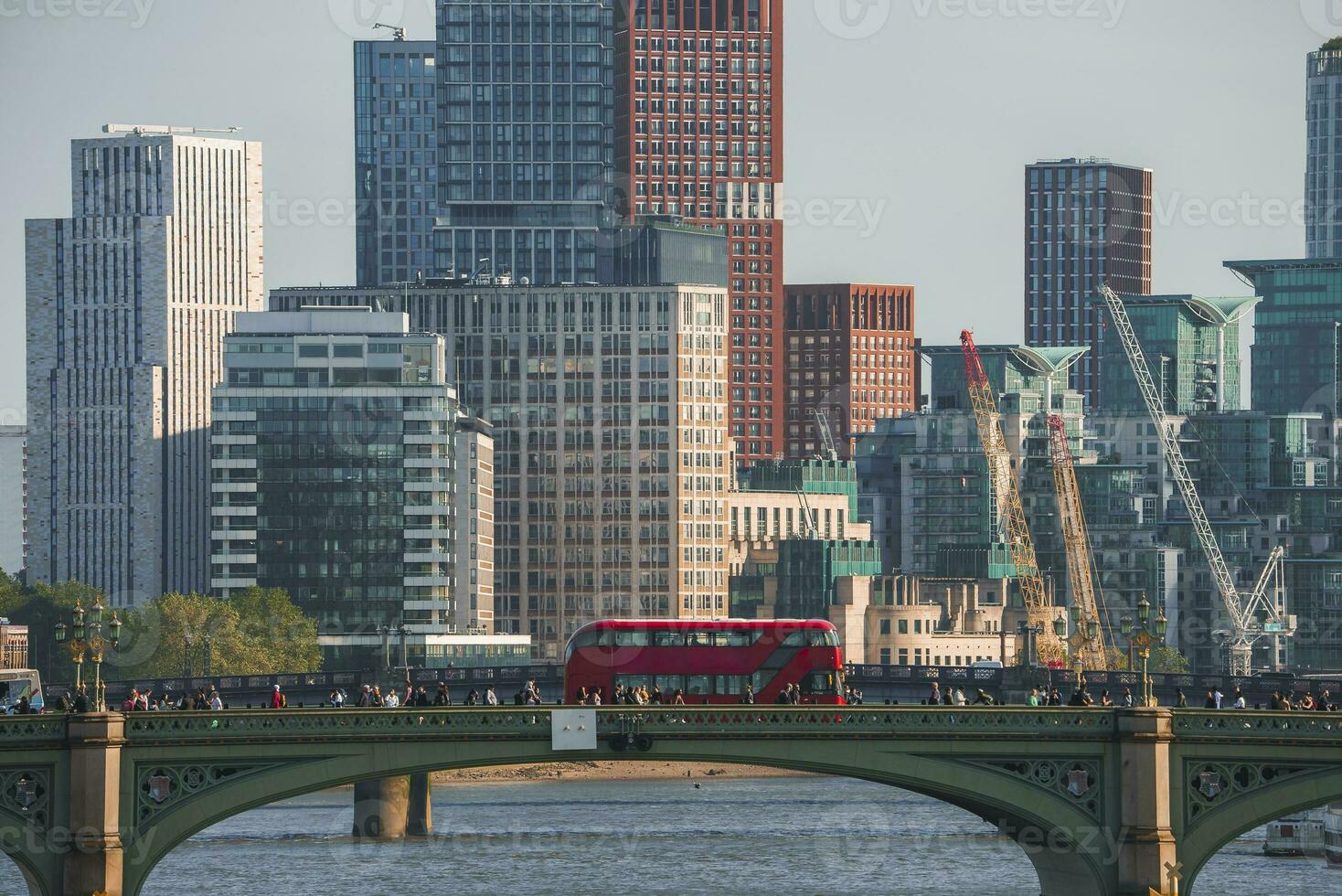 Tourists spending leisure time on Westminster bridge over Thames river in London photo