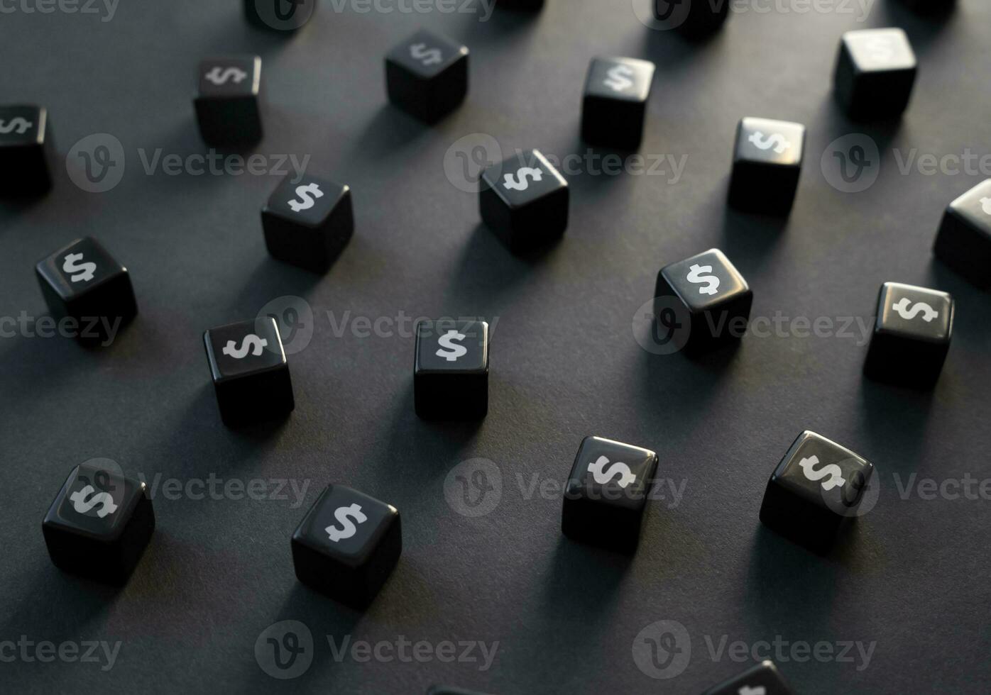 Dollar symbols on black blocks. Pessimistic economic forecasts. Reducing costs. Cutting spendings. Optimization of budget, tough economic times or inflation. photo