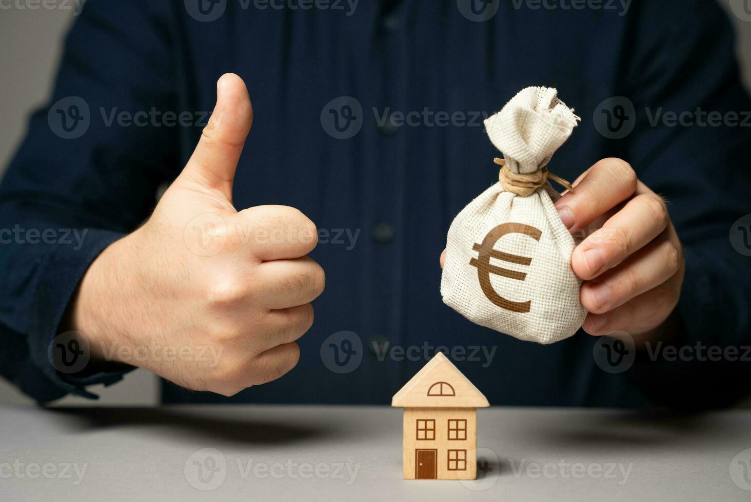 A man with a euro money bag approves a real estate deal. Buy or sell a
