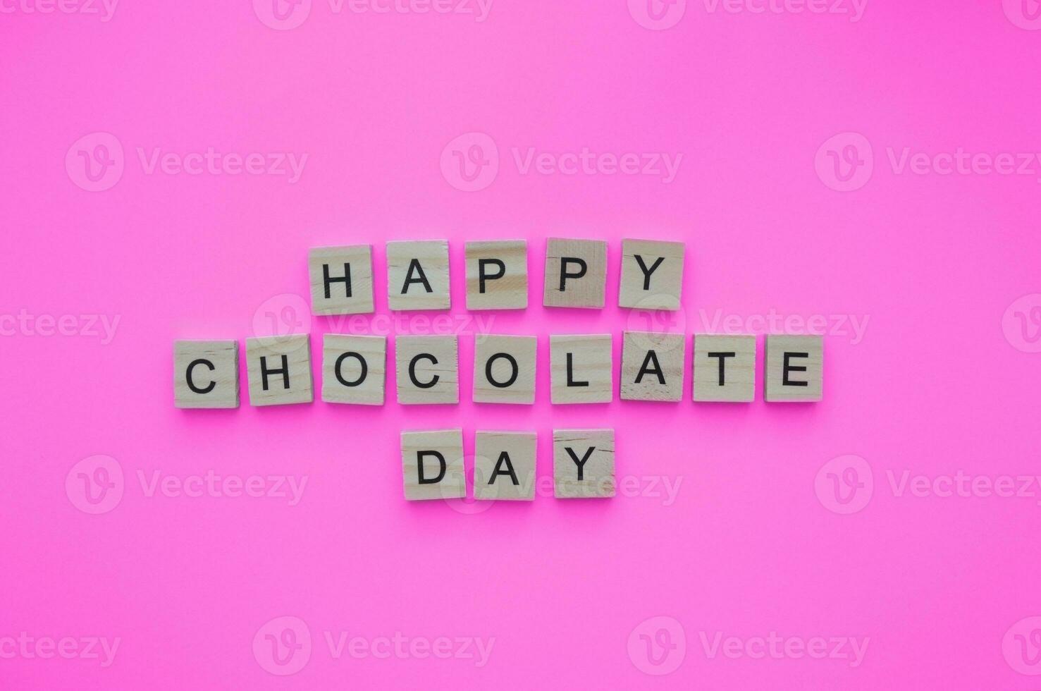 September 13, International Chocolate Day, minimalistic banner with the inscription in wooden letters on a pink background photo