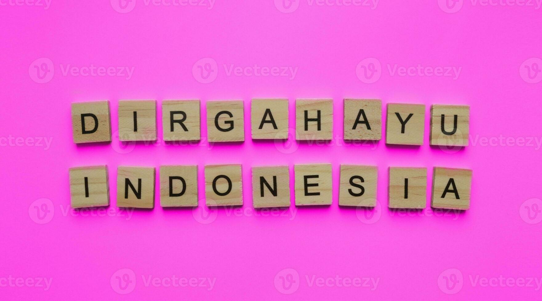 August 17, Indonesia Independence Day, minimalistic banner with the inscription in wooden letters Dirgahayu Indonesia photo