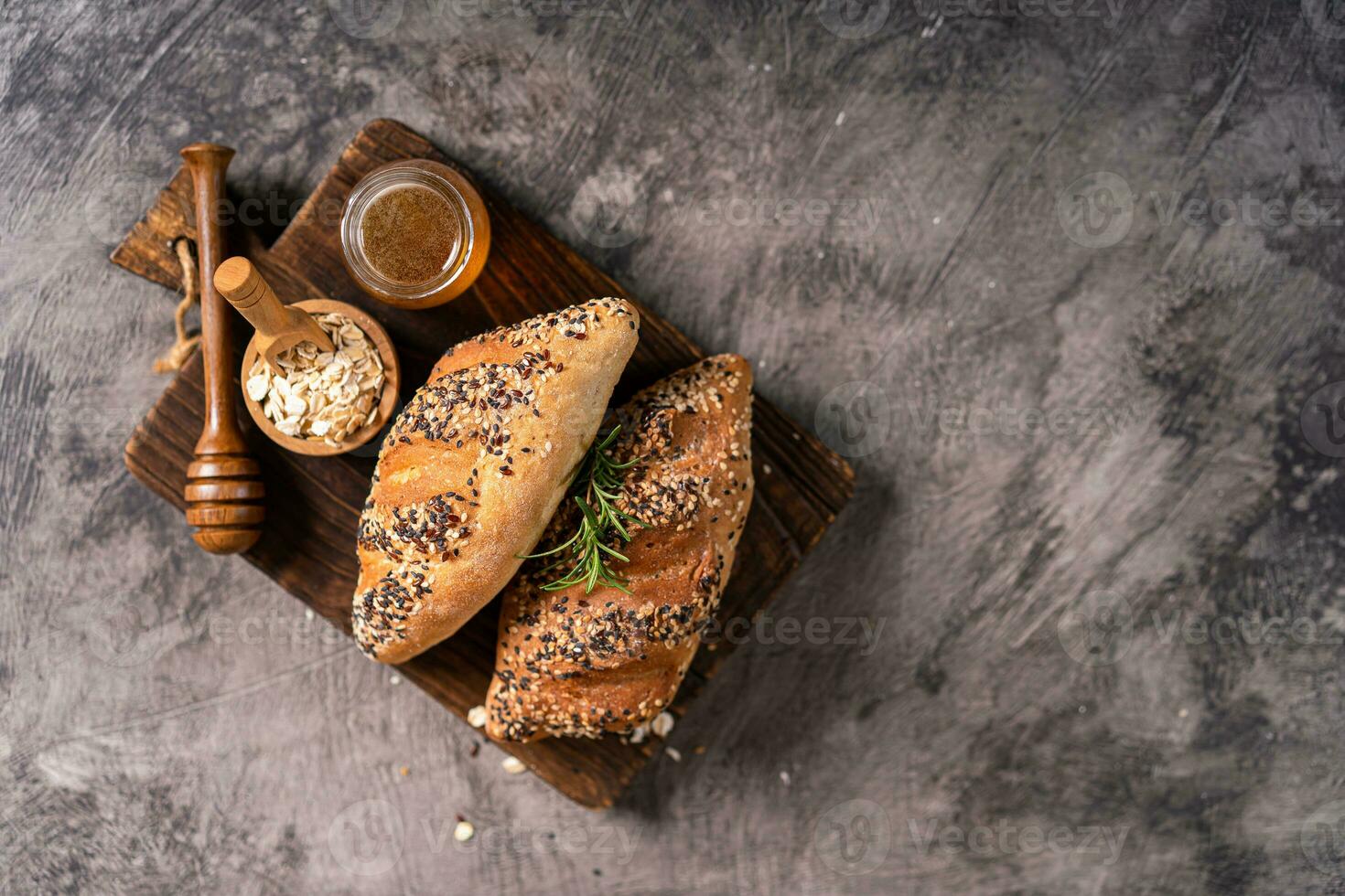 Fresh homemade bread whole wheat baguette on napkin and abstract table. Sourdough bread photo