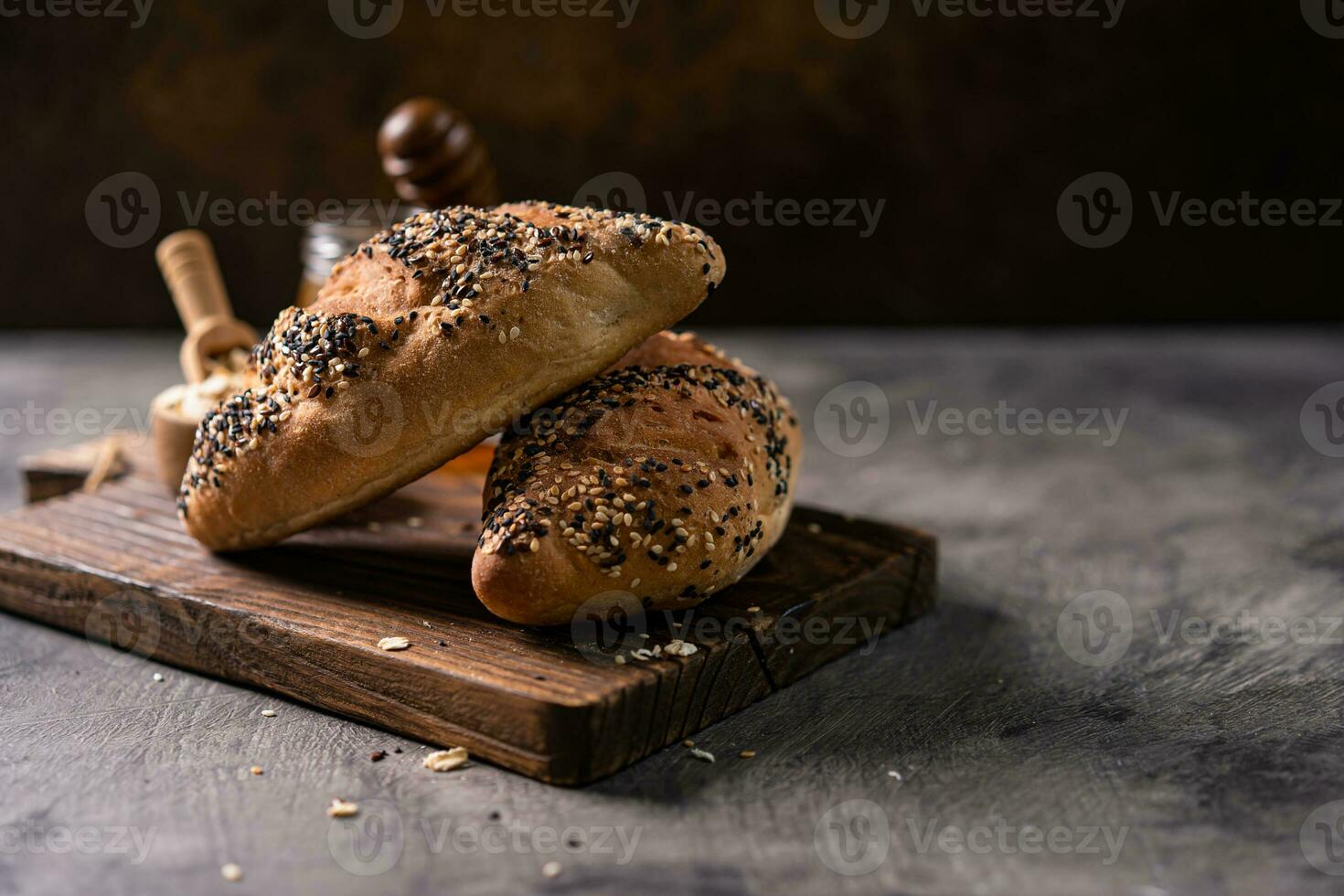 Fresh homemade bread whole wheat baguette on napkin and abstract table. Sourdough bread photo