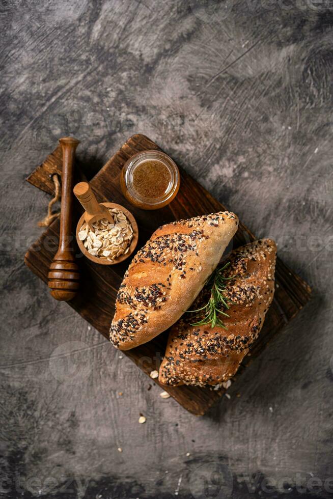 Fresh homemade bread whole wheat baguette on napkin and abstract table. Sourdough bread photo