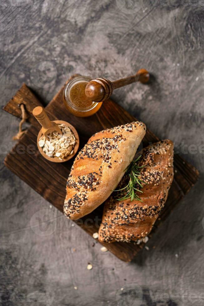 Fresh homemade bread whole wheat baguette on napkin and abstract table. Sourdough bread photo