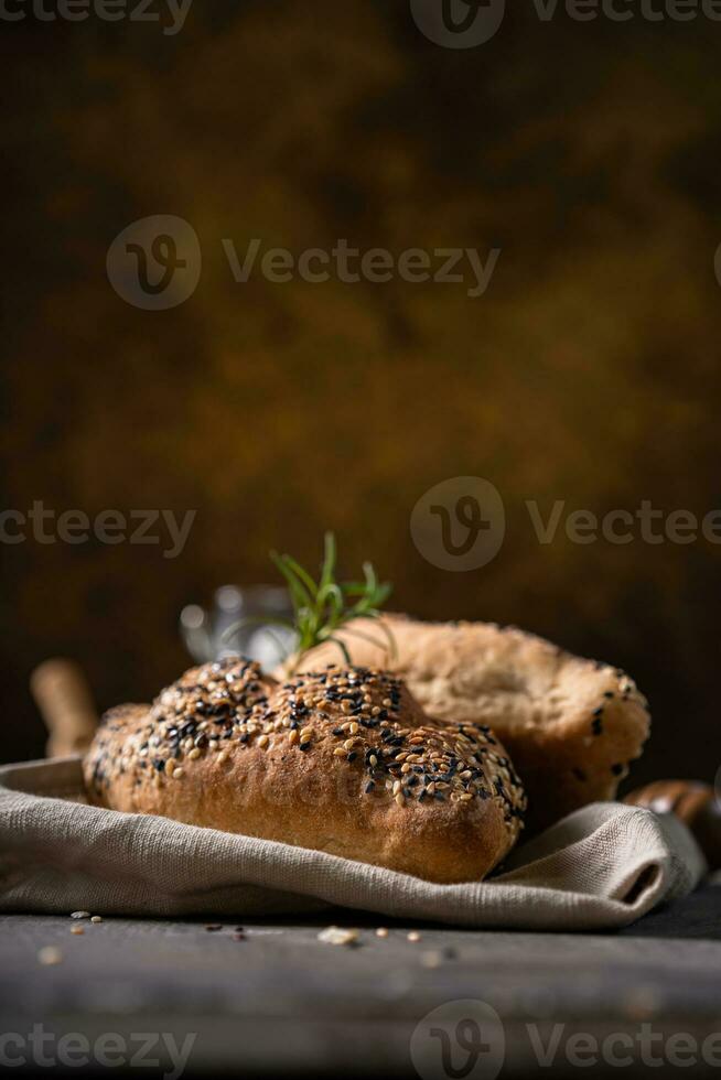 Fresh homemade bread whole wheat baguette on napkin and abstract table. Sourdough bread photo