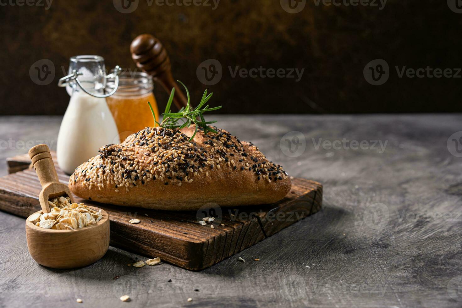 Fresh homemade bread whole wheat baguette on napkin and abstract table. Sourdough bread photo