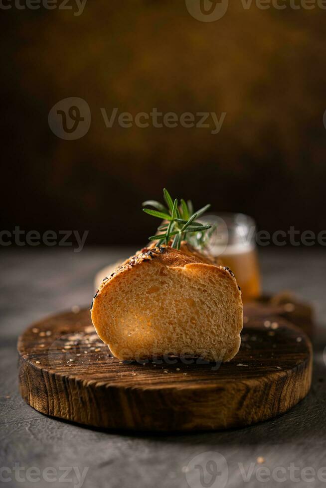 Artisan bread whole wheat baguette white milk and honey on rustic wooden board and abstract table. Sourdough bread photo