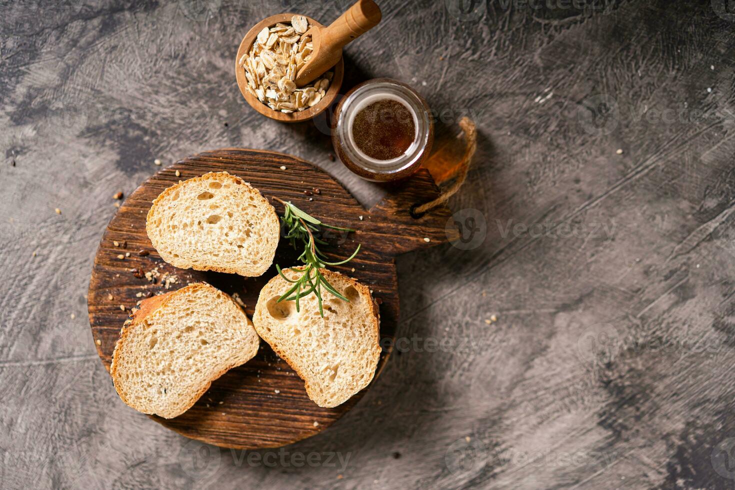 Artisan bread whole wheat baguette white milk and honey on rustic wooden board and abstract table. Sourdough bread photo