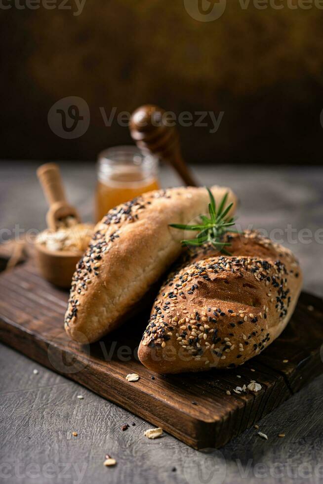 Fresh homemade bread whole wheat baguette on napkin and abstract table. Sourdough bread photo