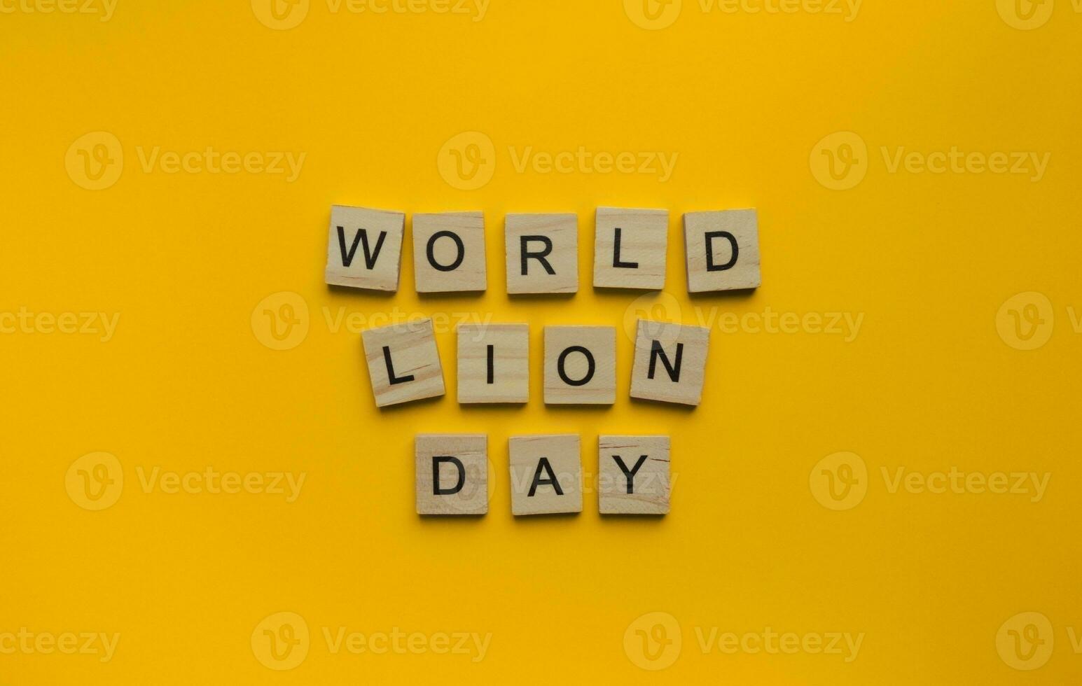 August 10, World Lion Day, minimalistic banner, inscription in wooden letters on an orange background photo