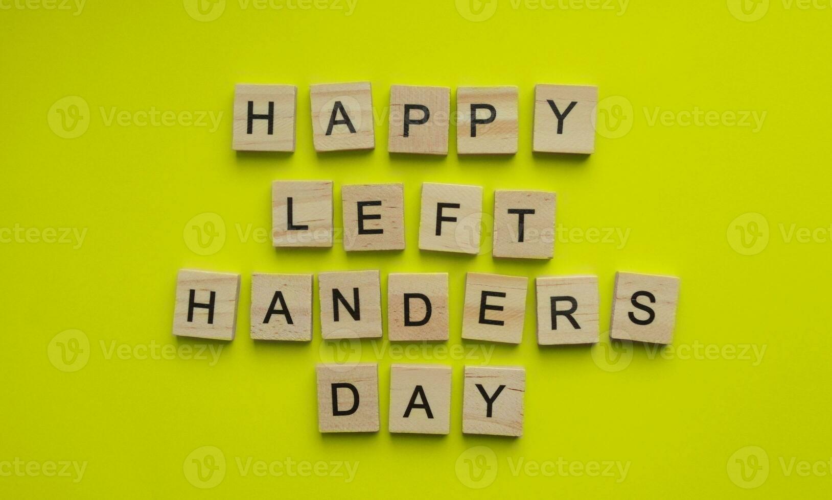 August 13, International Day of Lefties, Lefthanders Day, minimalist banner with the inscription in wooden letters on a yellow background photo