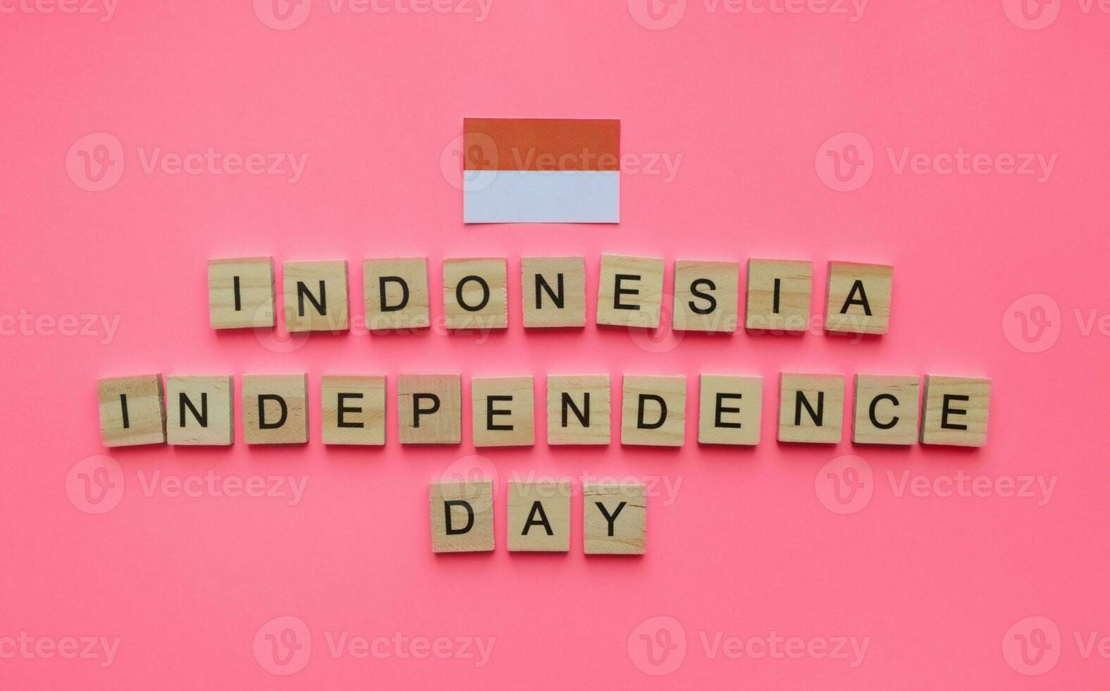 August 17, Indonesia Independence Day, flag of Indonesia, minimalistic banner with the inscription in wooden letters on a red background photo