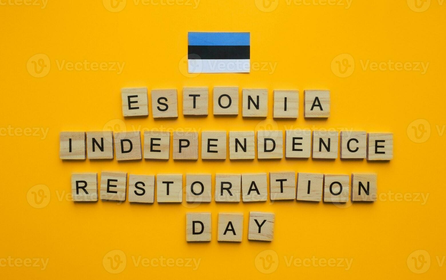 August 20, Estonia Independence Restoration Day, flag of Estonia, minimalistic banner with the inscription in wooden letters on an orange background photo