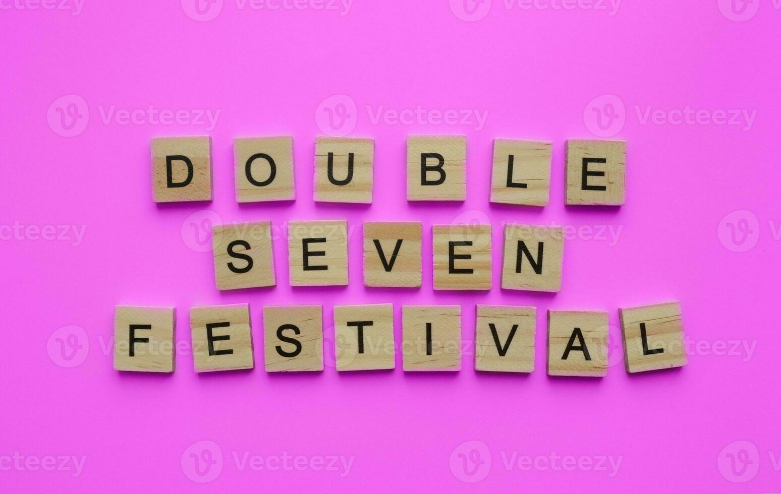 August 22, QiXi Festival, Double Seven Festival, Chinese Valentines Day, minimalistic banner with the inscription in wooden letters on a pink background photo