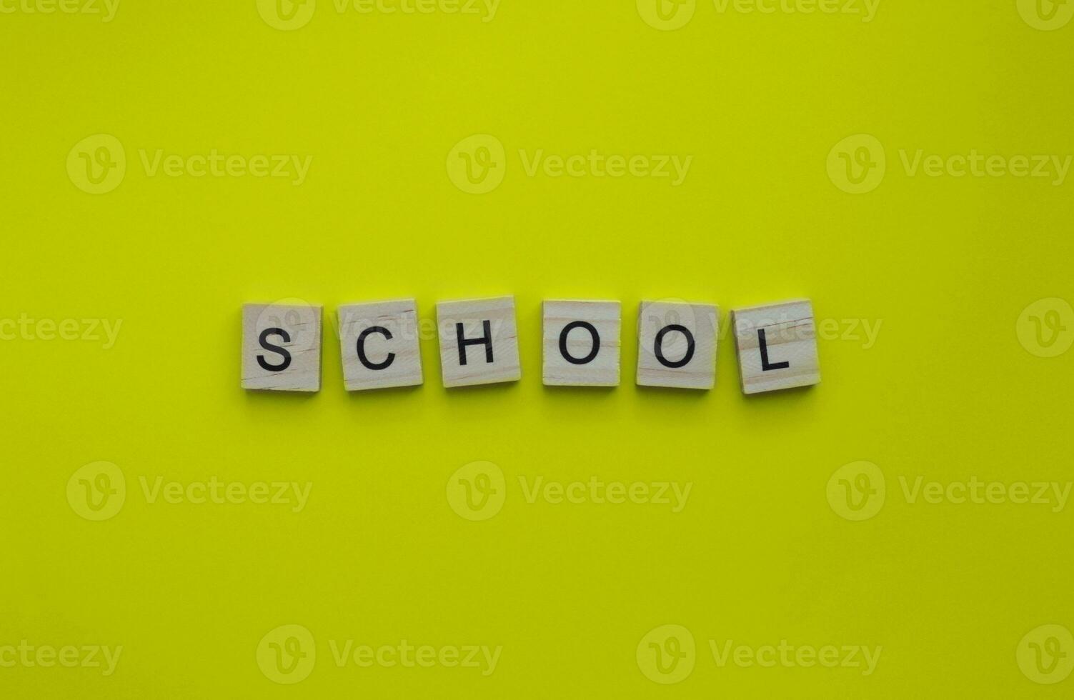 September 1, Knowledge Day, Back to school, minimalistic banner with the inscription in wooden letters on a yellow background photo