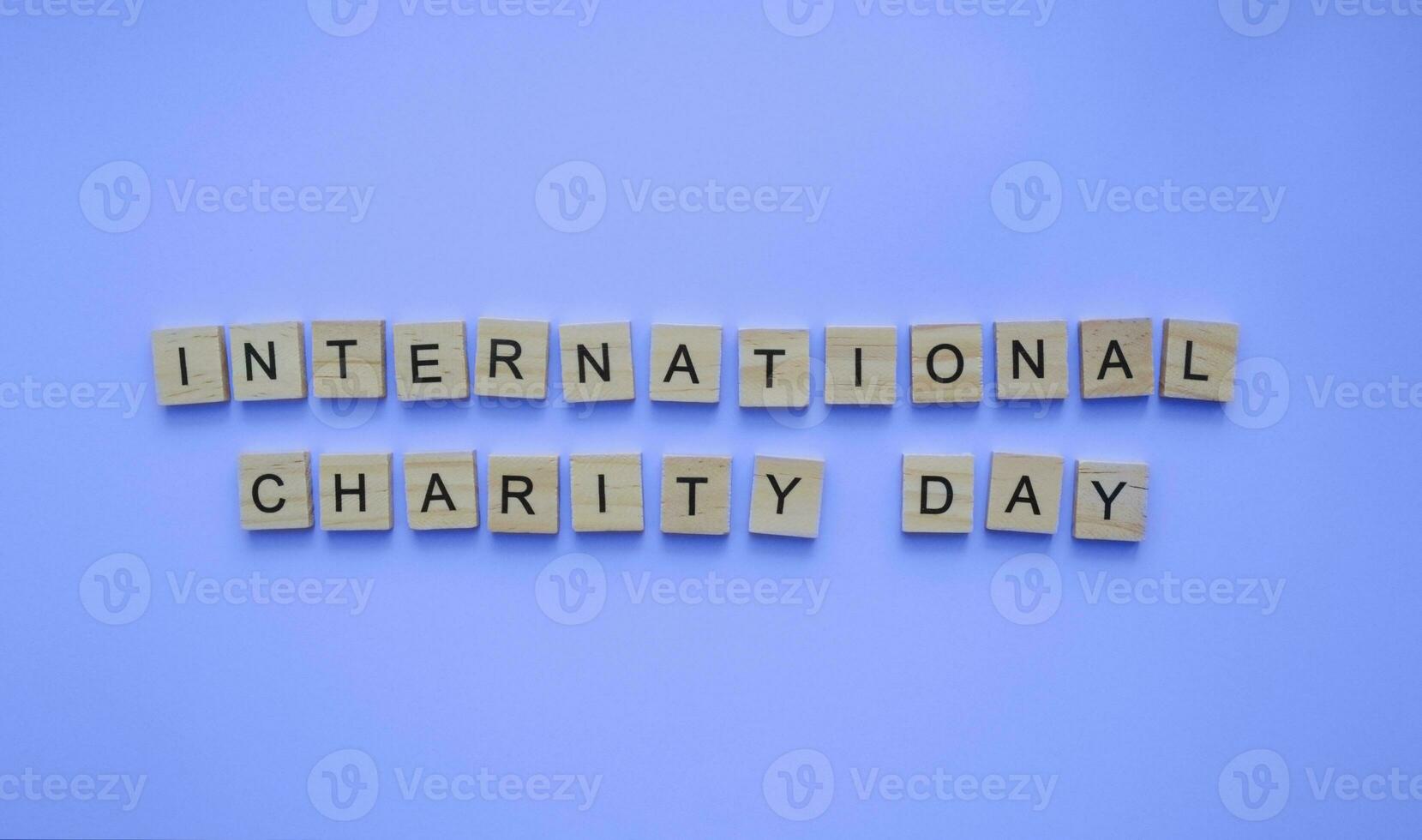 September 5, International Day of Charity, minimalistic banner with the inscription in wooden letters photo