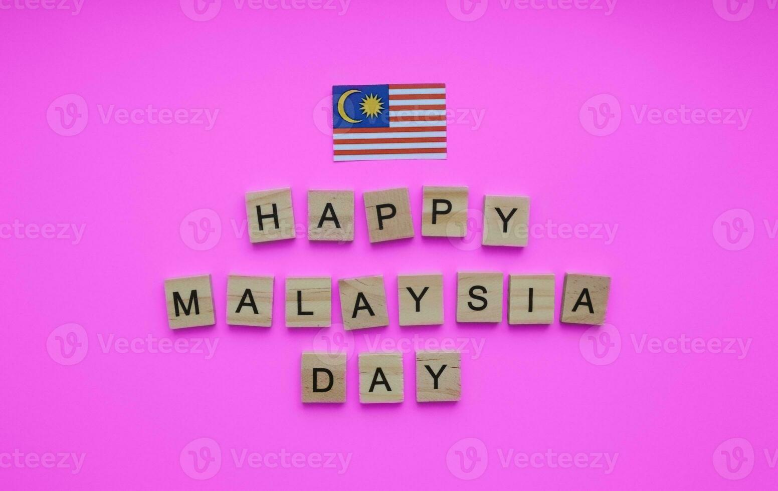 September 16, happy Malaysia Day, flag of Malaysia, minimalistic banner with the inscription in wooden letters photo