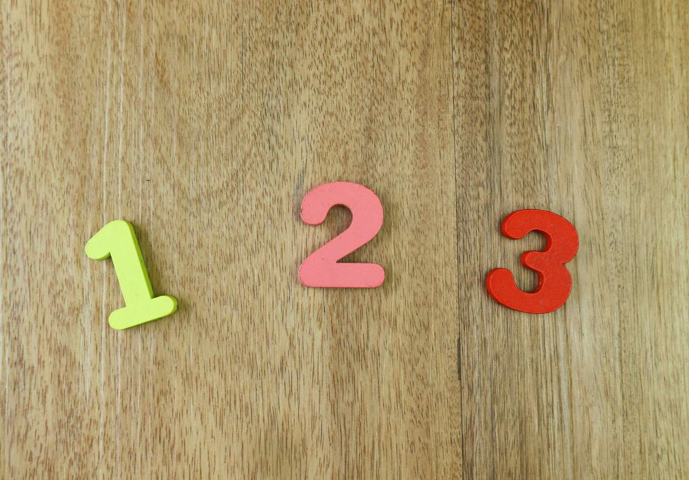 Number one, two and three on the wooden background photo