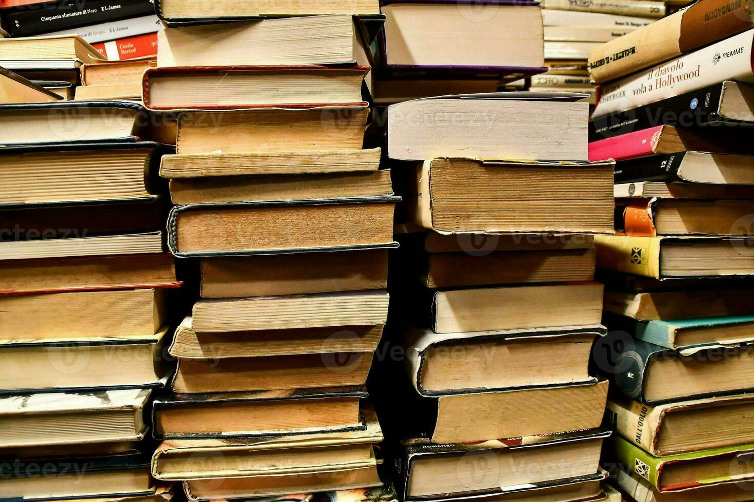a pile of books is shown in a room photo