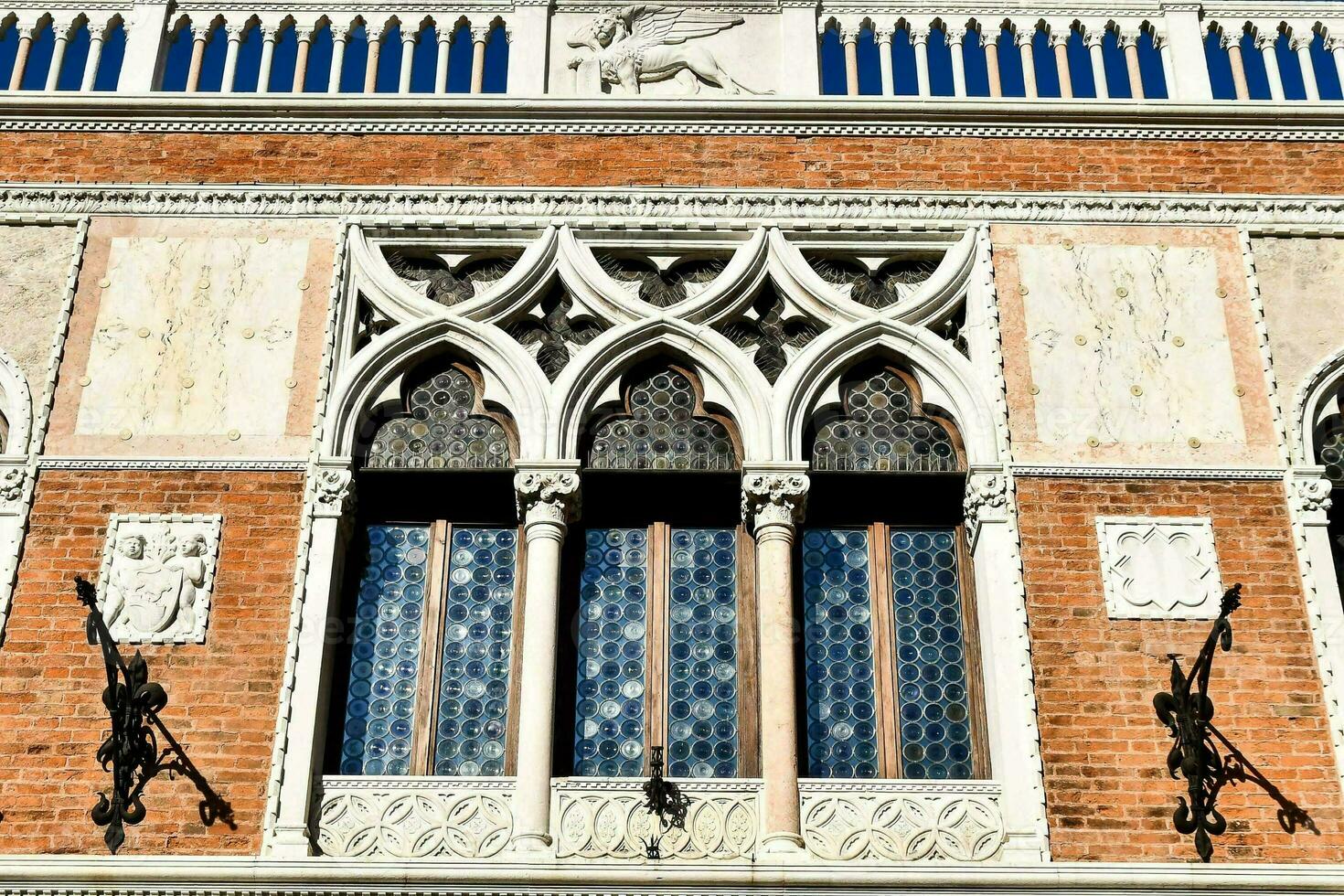 the facade of a building with ornate windows photo