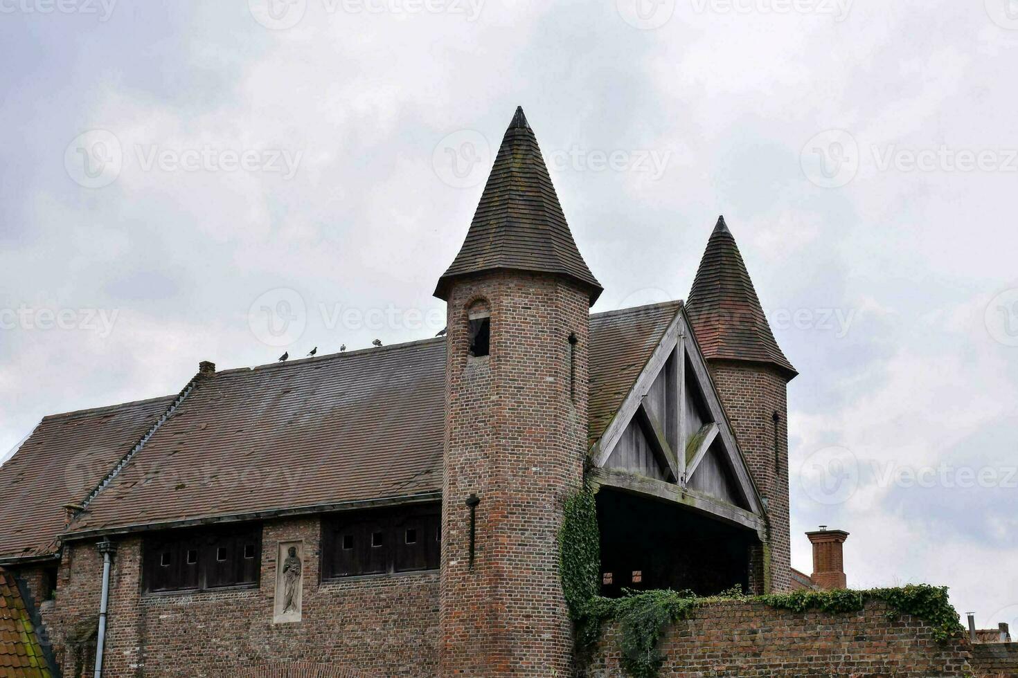 a large brick building with two towers photo