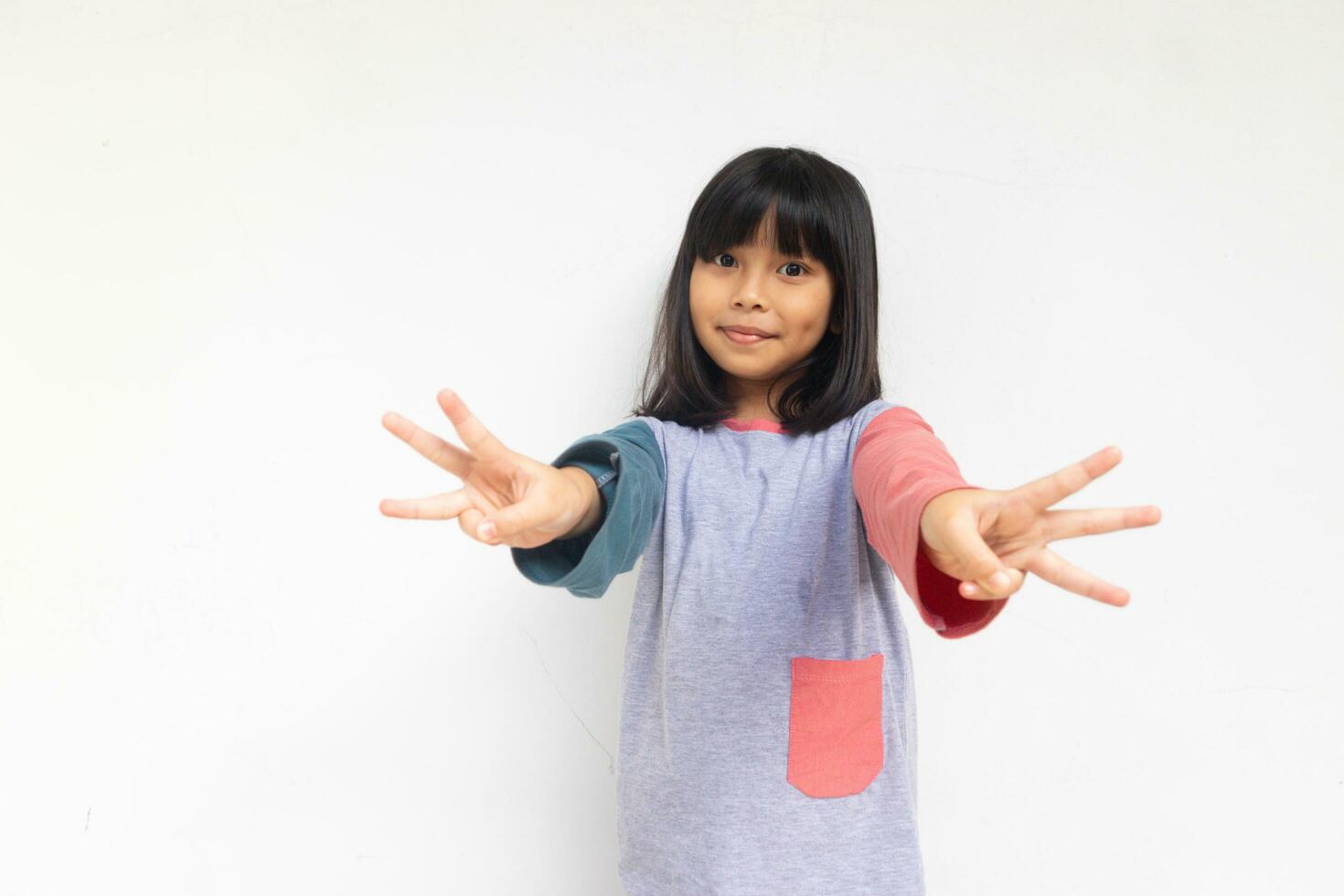 A cute girl raised hand to show six of her fingers photo