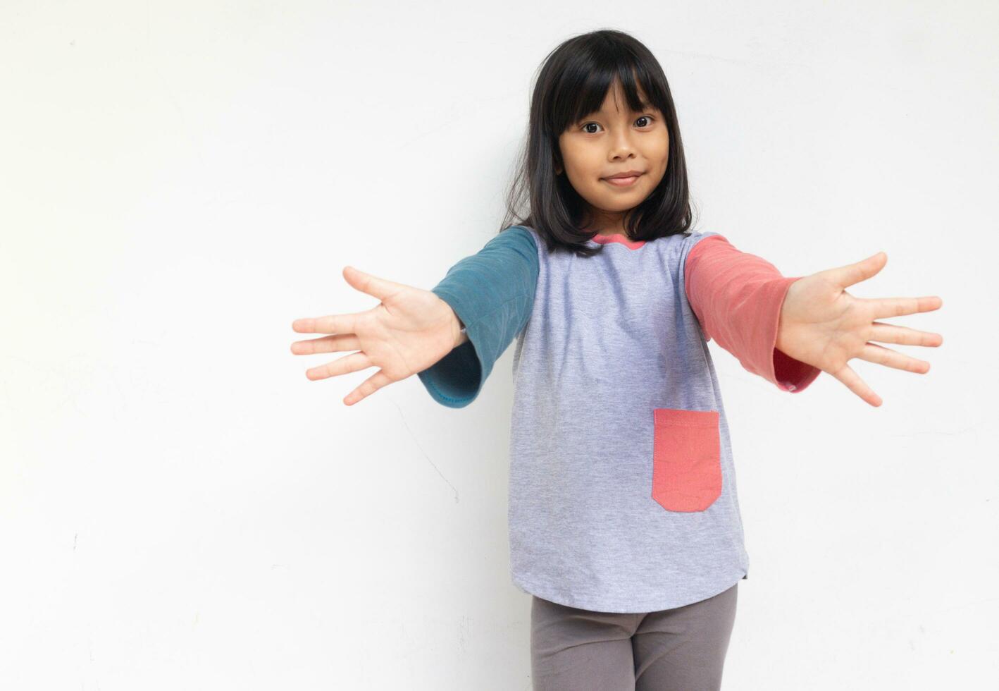 A cute girl raised her hand to show welcome gesture. photo