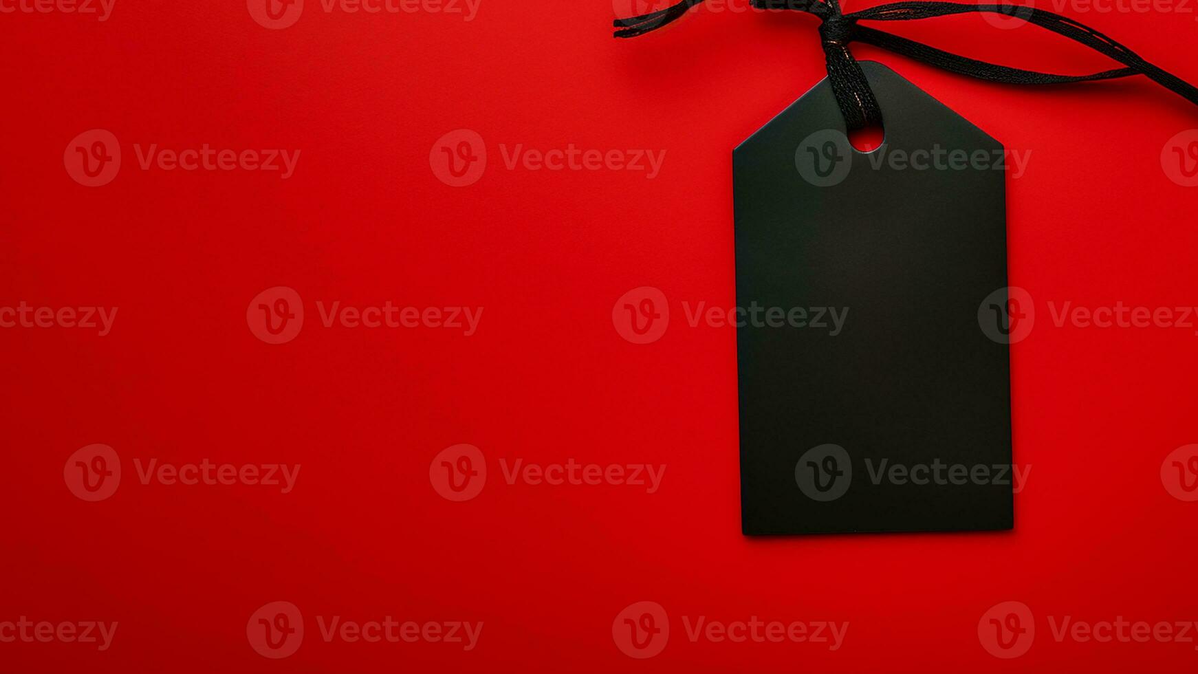 Black empty price tag on red background. Black Friday concept, template copyspace photo