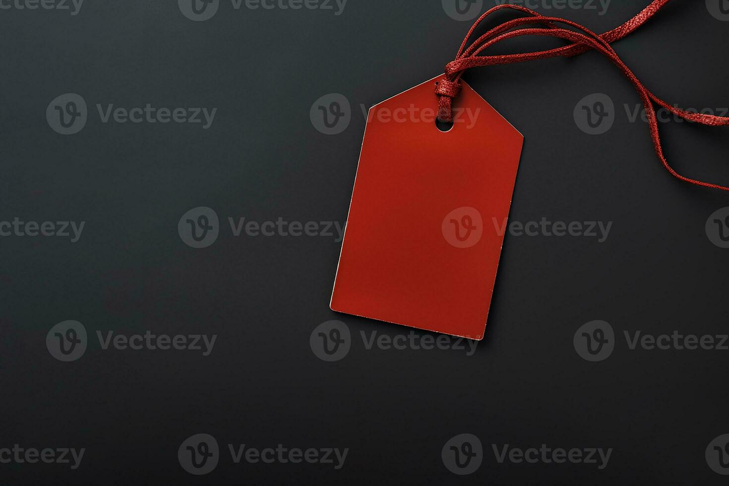 Red empty price tag on black or dark background. Black Friday concept, template copyspace photo