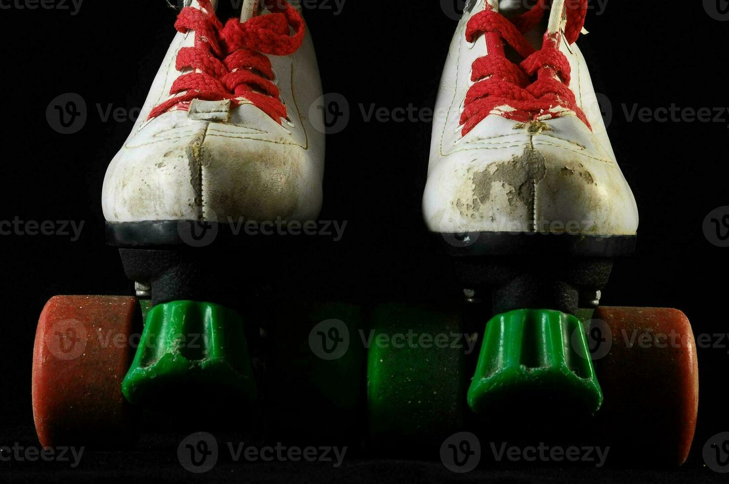 a pair of roller skates with green and red wheels photo