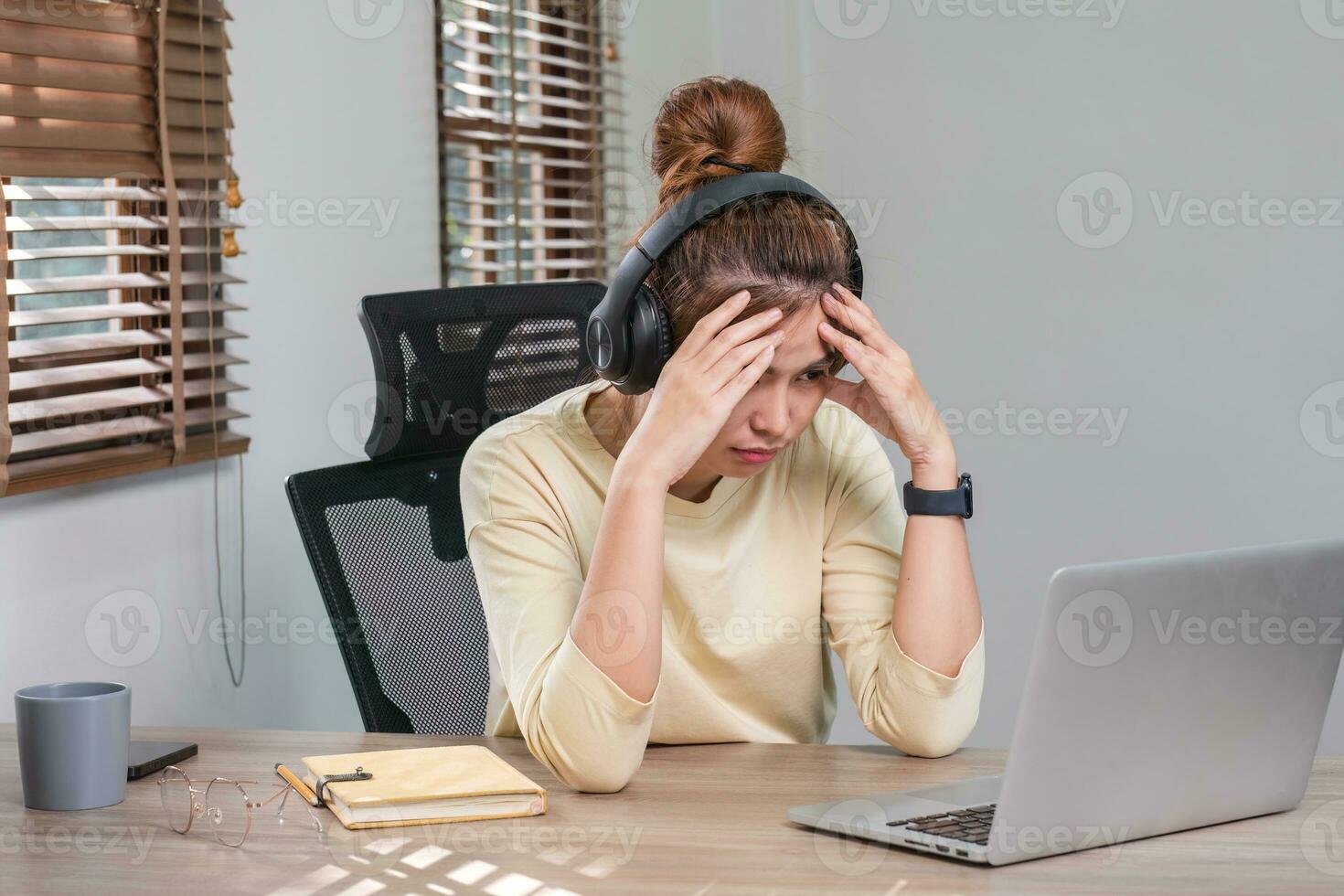 Asian women are bored from their online studies, have a sad face and have been tired from their studies for a long time. photo