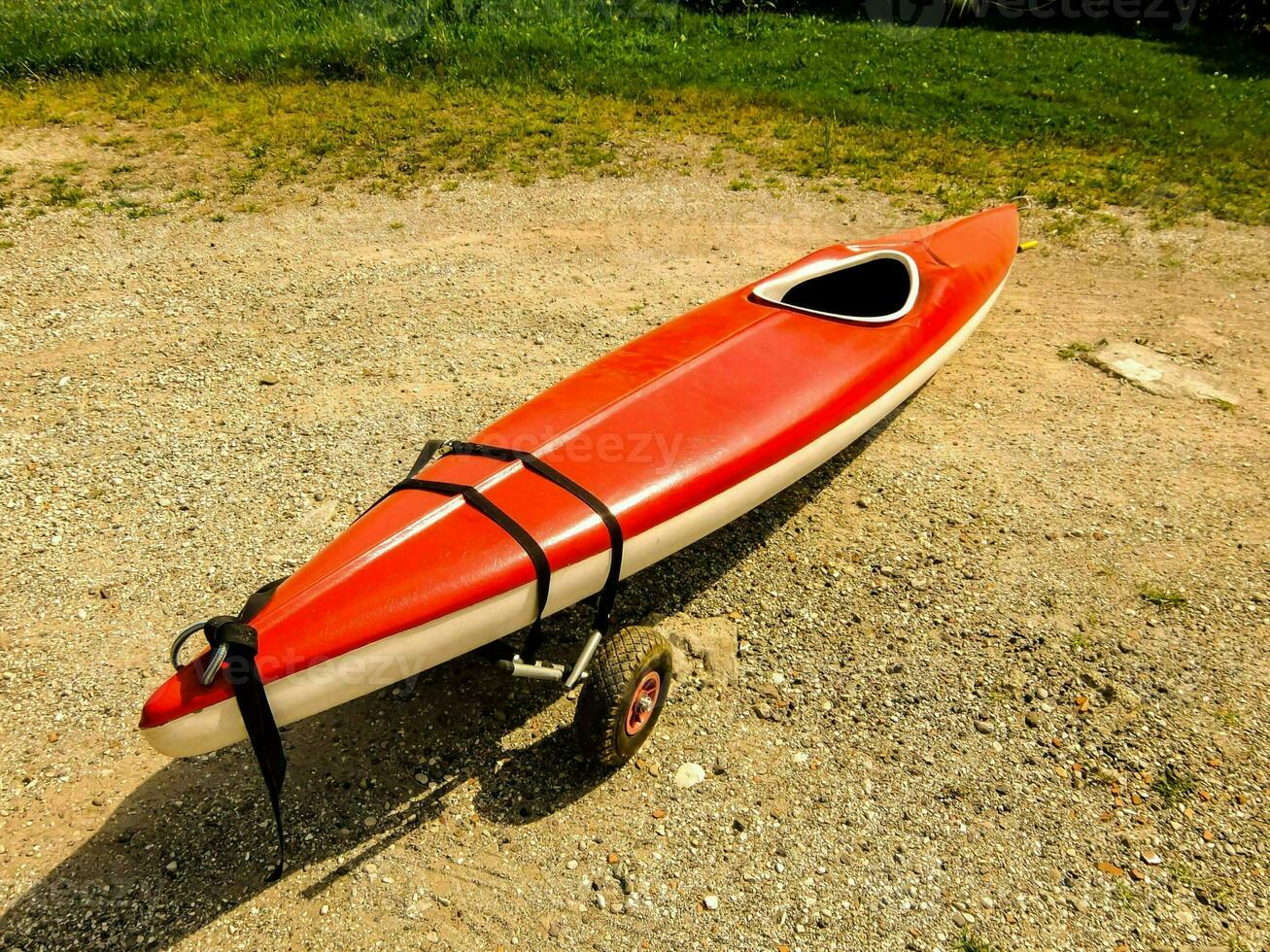 a red kayak on a trailer with a white seat 27231986 Stock Photo at Vecteezy