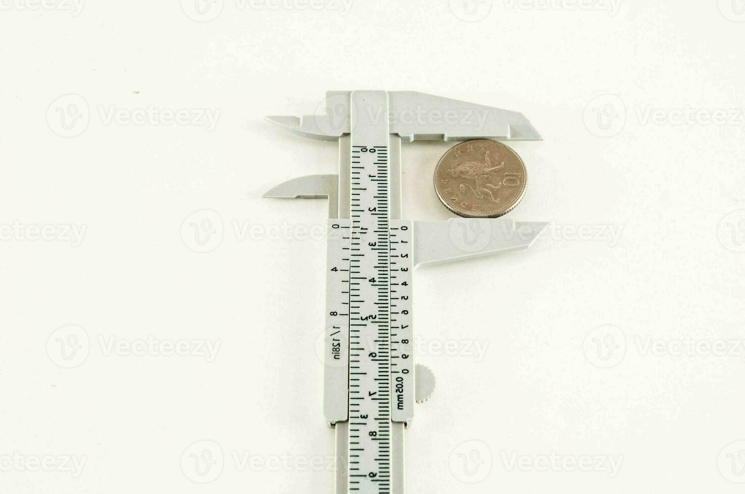 a caliper is holding a penny on a white background photo
