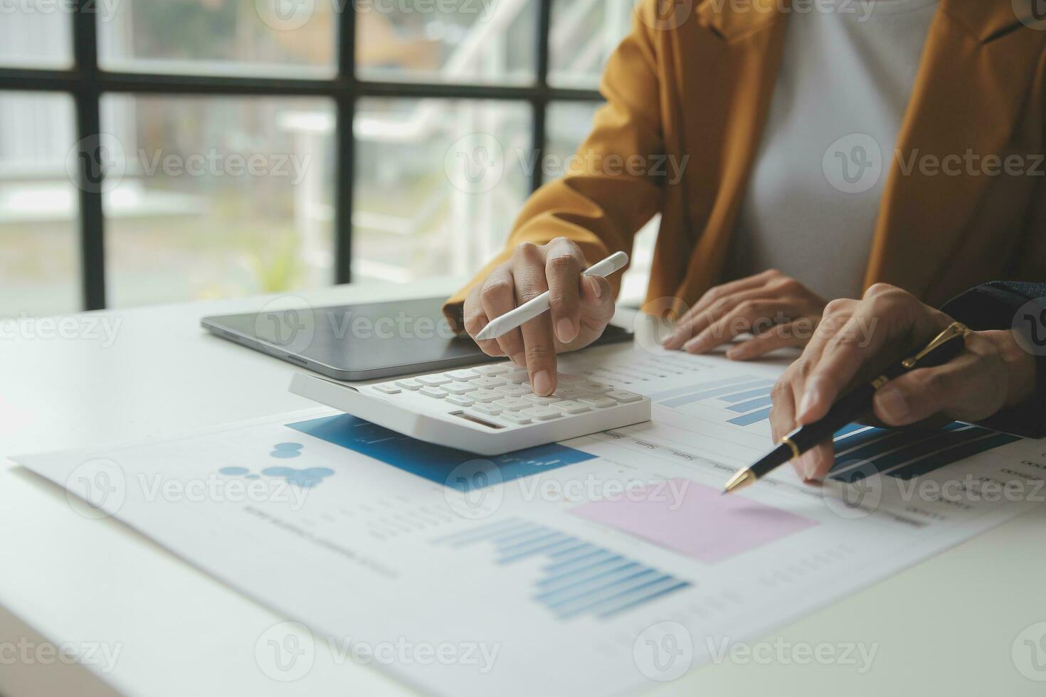 Accounting businessman working on laptop computer and analyzing real estate investment data, Financial and tax systems concept. photo